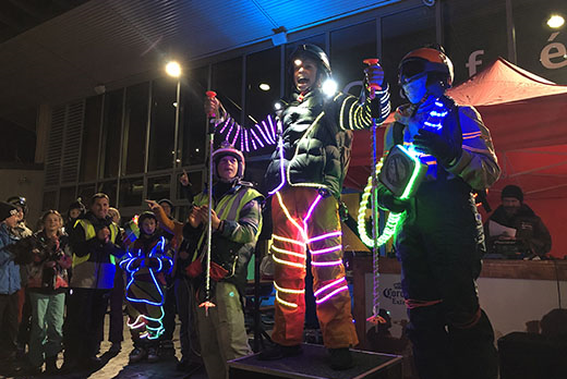 Ākonga standing on a podium wearing their light suits.  