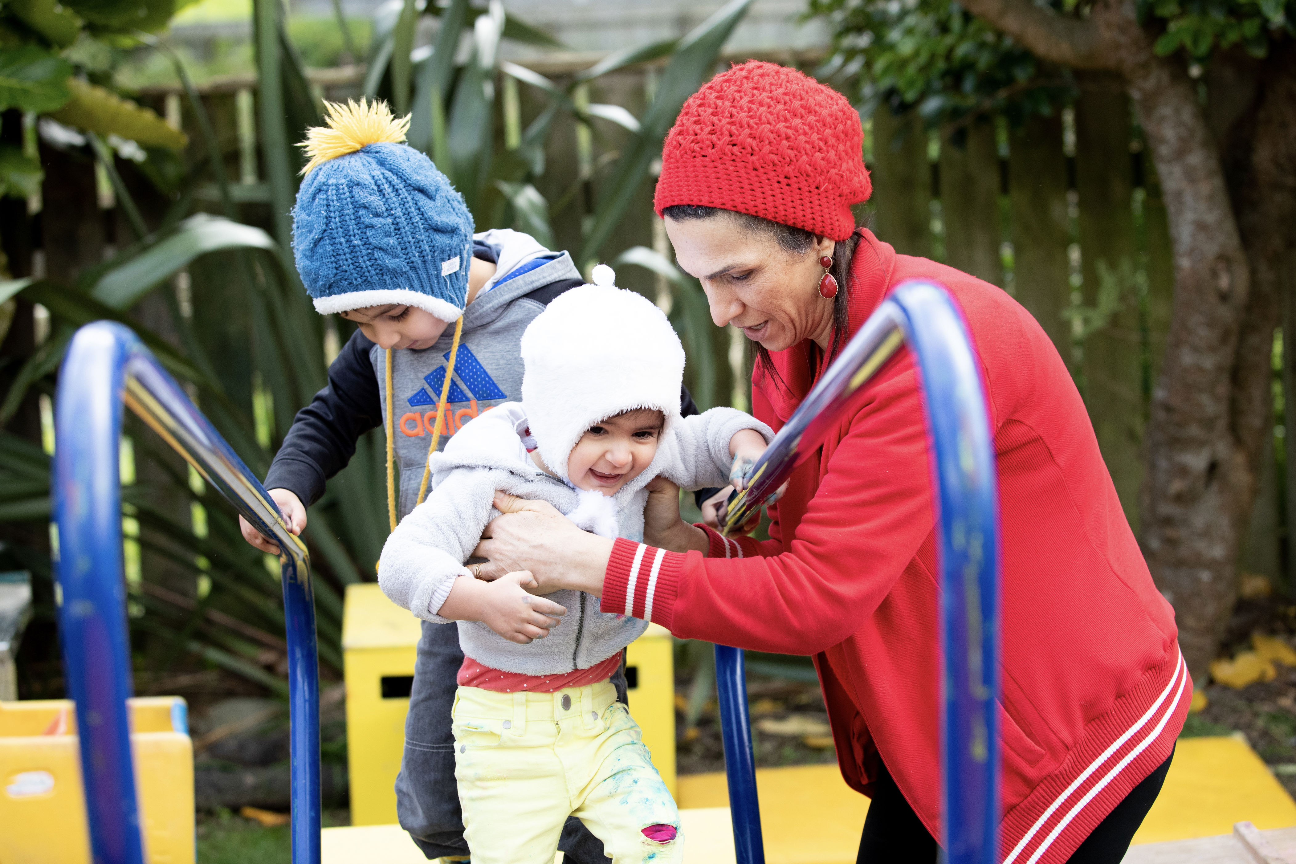 Parent and child playing on climbing equipment at playcentre