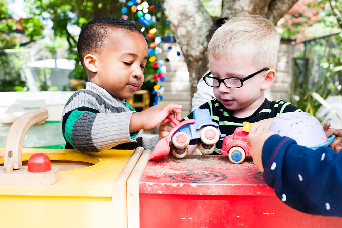 Two young boys playing outside together.