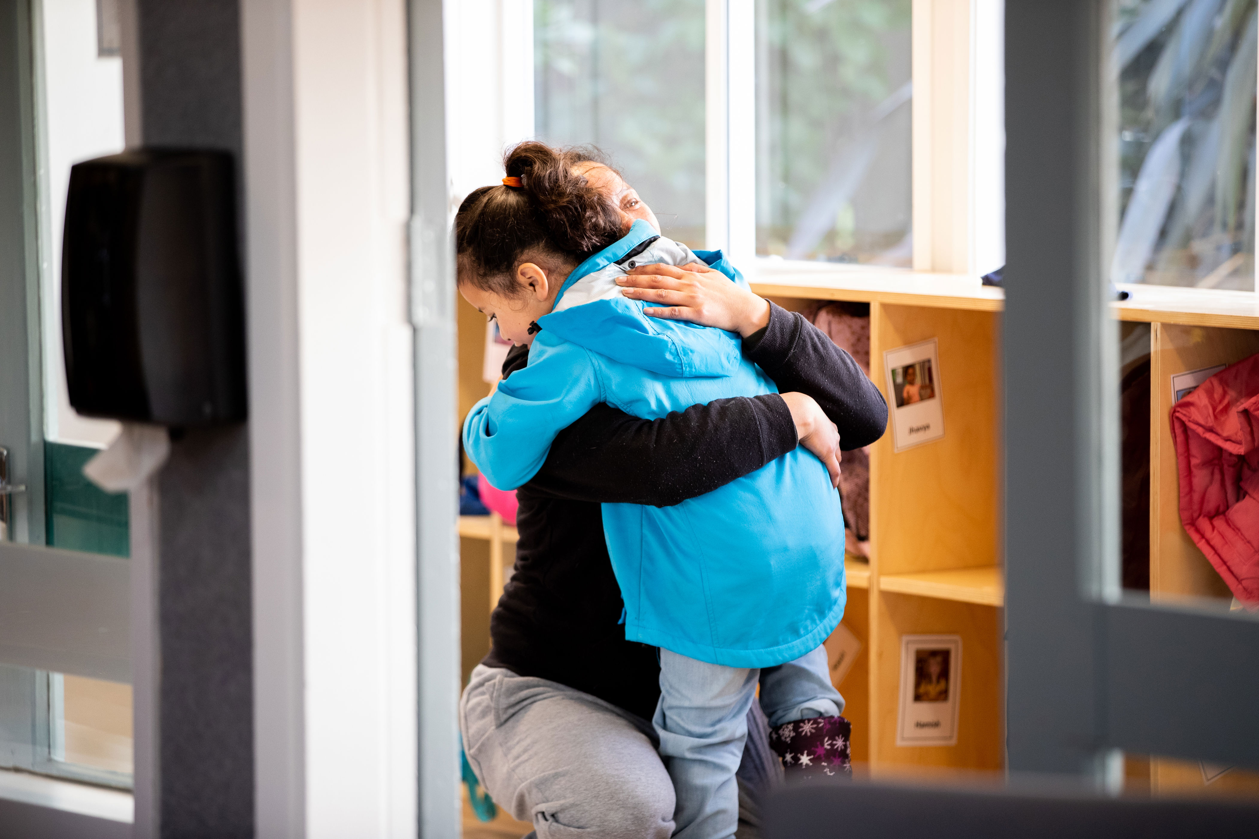 A parent hugging a child