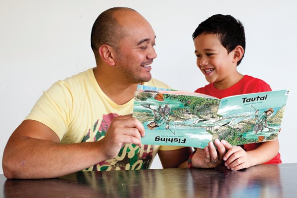 adult reading a storybook with a child