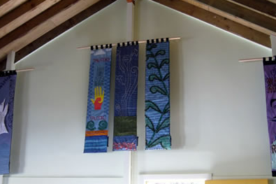 Five completed panels hanging against the wharenui wall. 