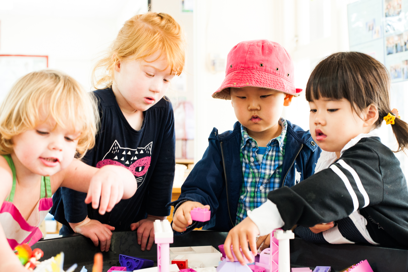 A group of children from different cultural backgrounds all playing together