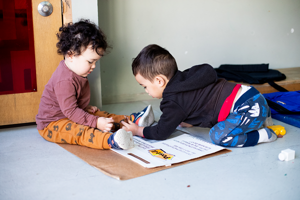 two children playing together on the floor