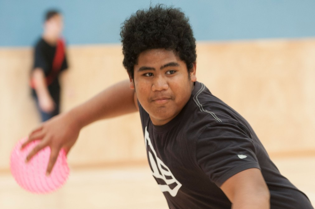 A teenage boy playing ultimate frisbee.