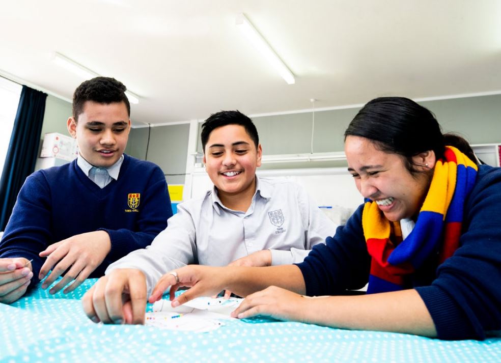 Three students sewing.jpeg