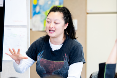 Kaiako using a laptop and screen to engage students.