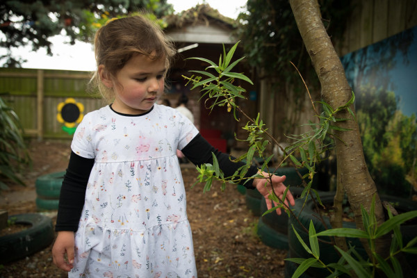 A child in the garden looking at plants