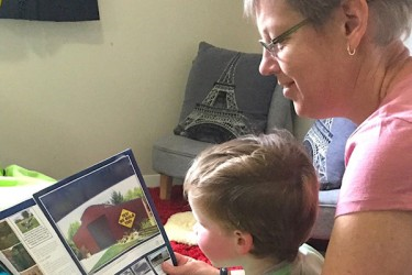 Adult and child reading together.