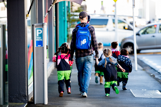 children walking with kaiako along the street to a local museum