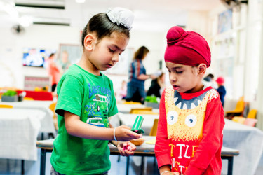 Two tamariki playing together