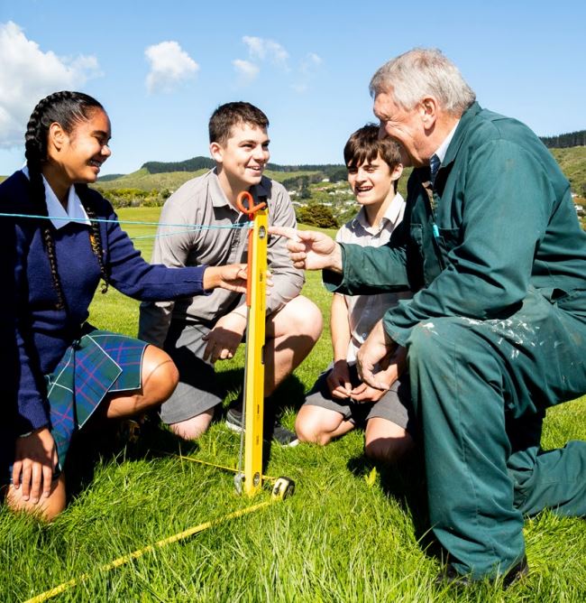 Three students listening to a farmer.jpeg