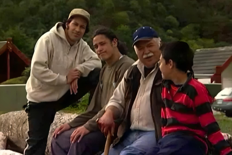 Koro Manu, Haami, Waka and Nui sitting outside, speaking.