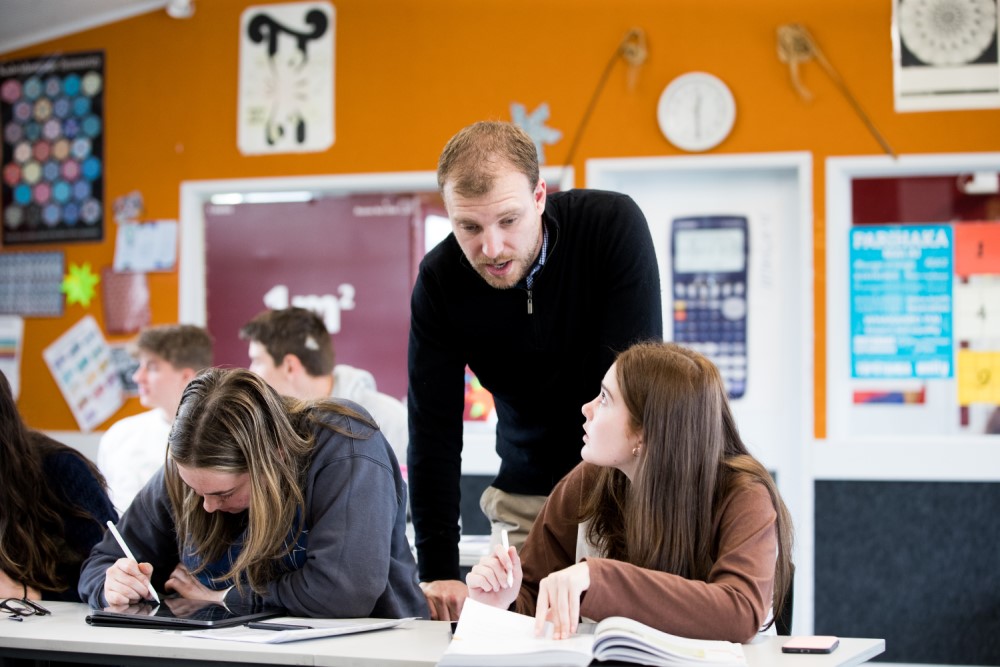 Teacher talking with students.