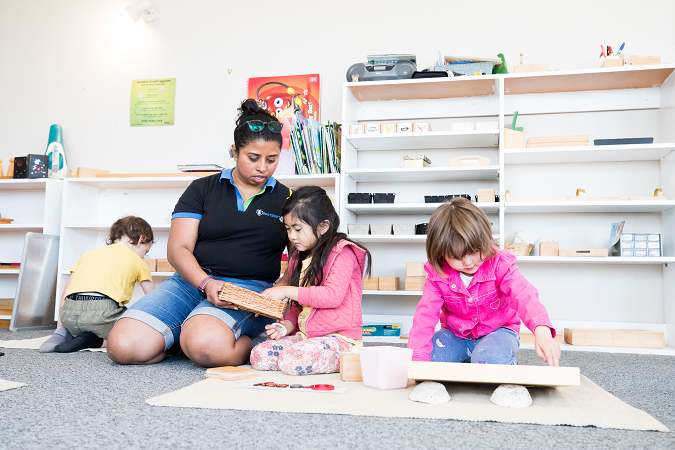 Kiako with three children in the playroom