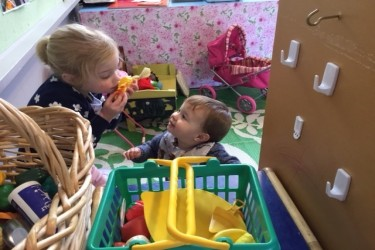 Two toddlers playing with toys together.