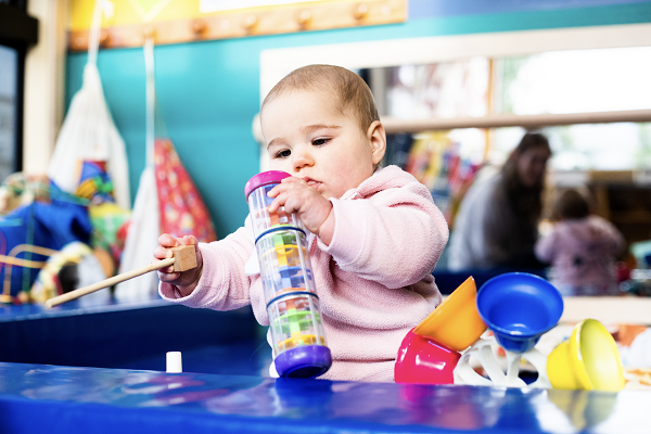 infant playing with building blocks