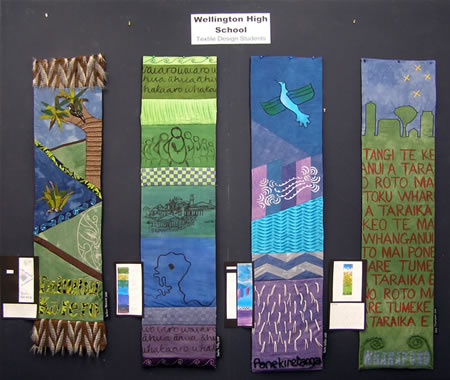 Four completed panels on display in a Wellington embroidery store.