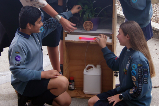 Two ākonga working on the self-watering plant system