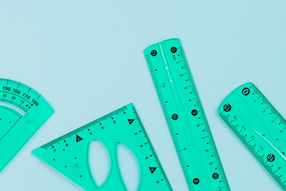 A series of different shaped rulers in a row.
