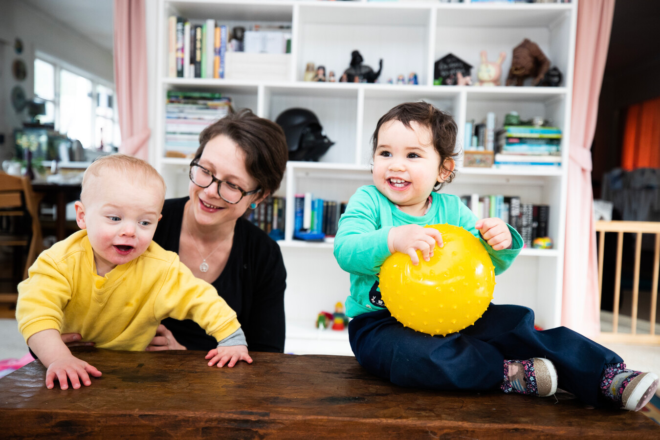 Children playing with teacher in home-based early learning.