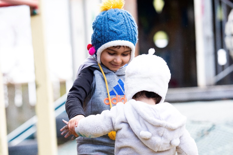 two children playing crossing bridge