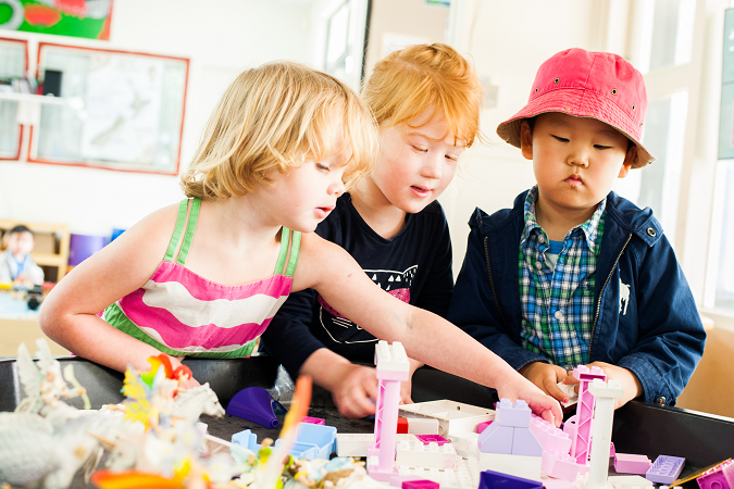 three children playing together in an early learning service