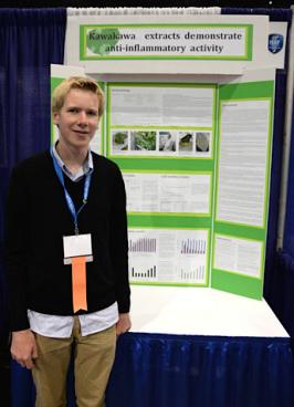 Chris standing in front of his Kawakawa extract scientific presentation.