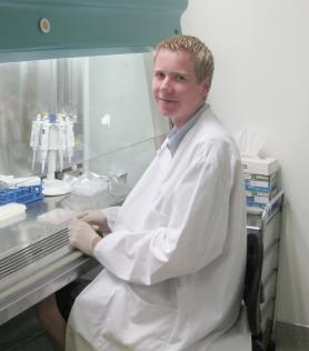 Chris sitting at his workstation in the lab.