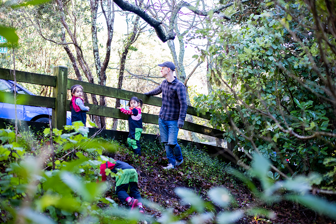 kaiako and children exploring a bank outdoors