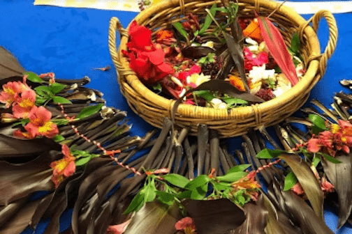 Woven basket with flowers and leaves surrounded a decoration with flowers