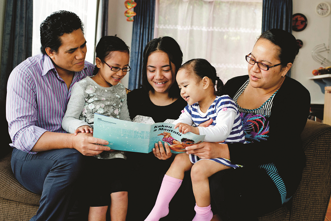 A family reading together on the couch