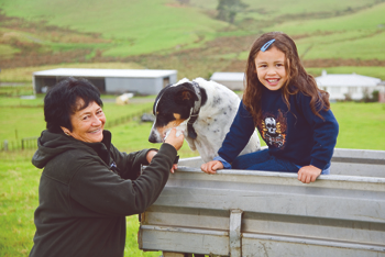 Adult, child and dog on farm