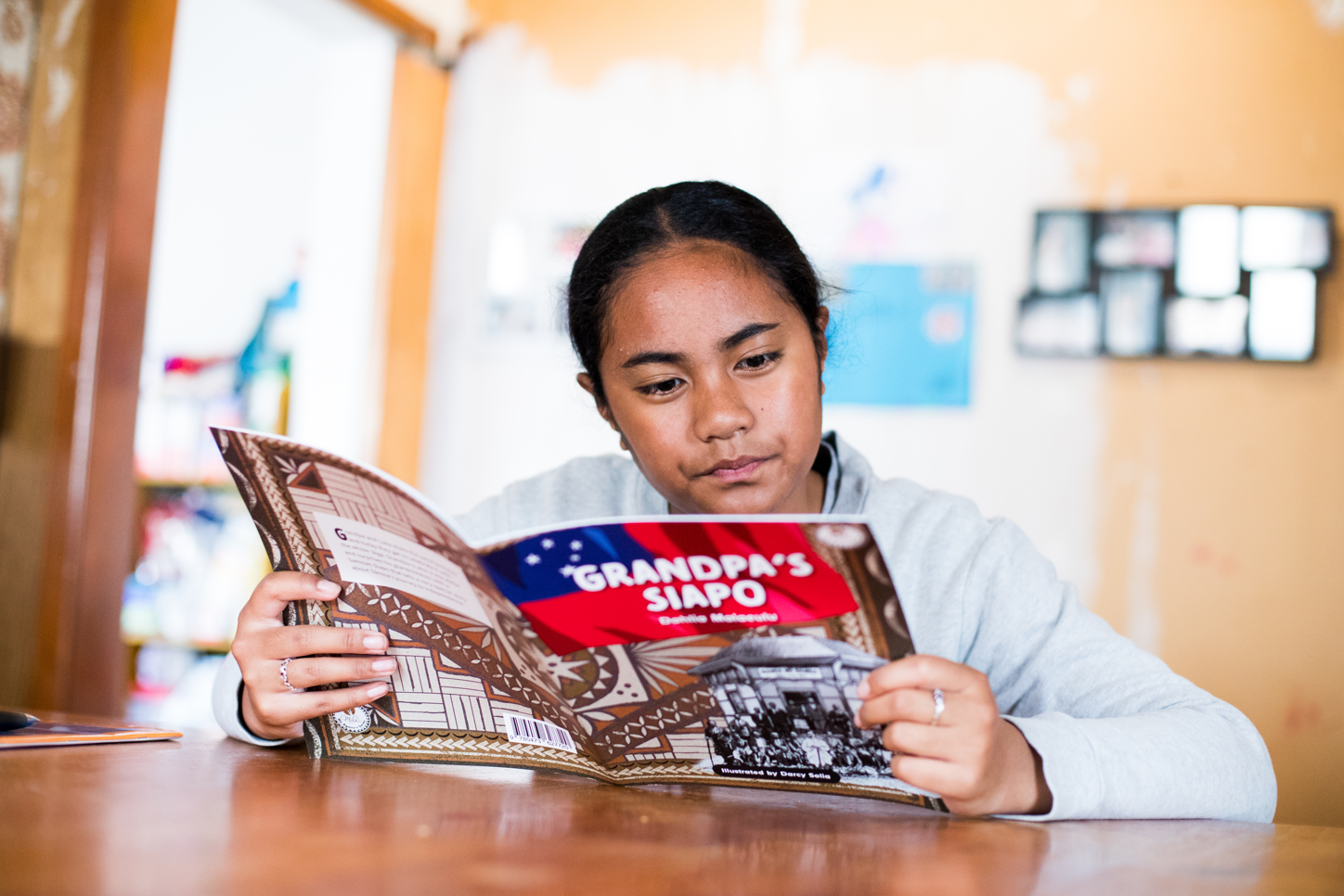 An ākonga reading a book.