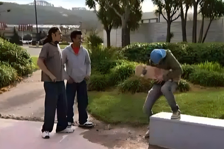 Dylan using his skateboard as an air guitar.