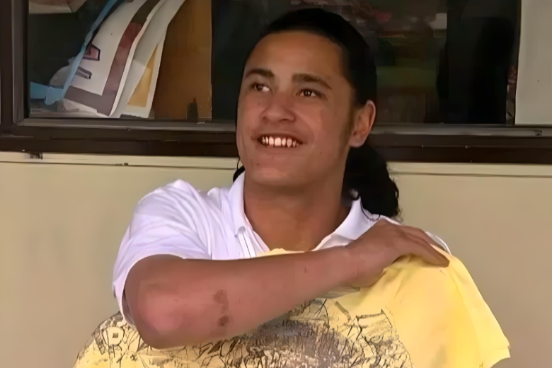 Haami holding a yellow t-shirt.
