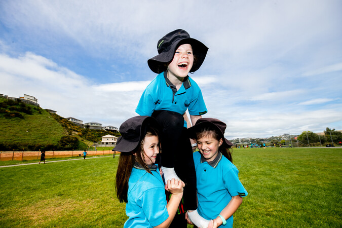 Students playing together on a field.