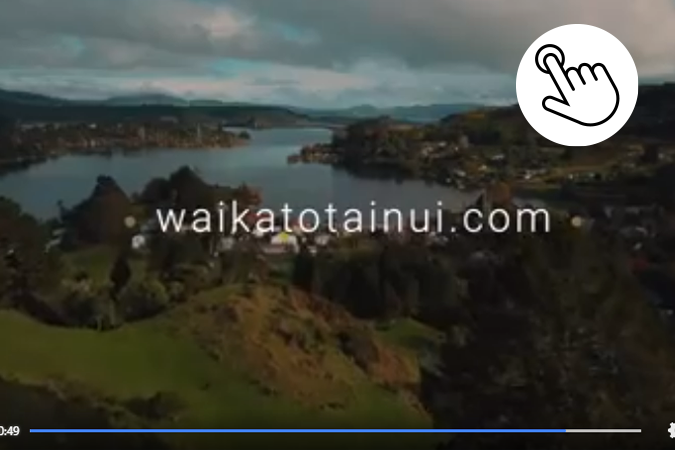 Waikato lake image with WaikatoTainui.com and prompt to click here