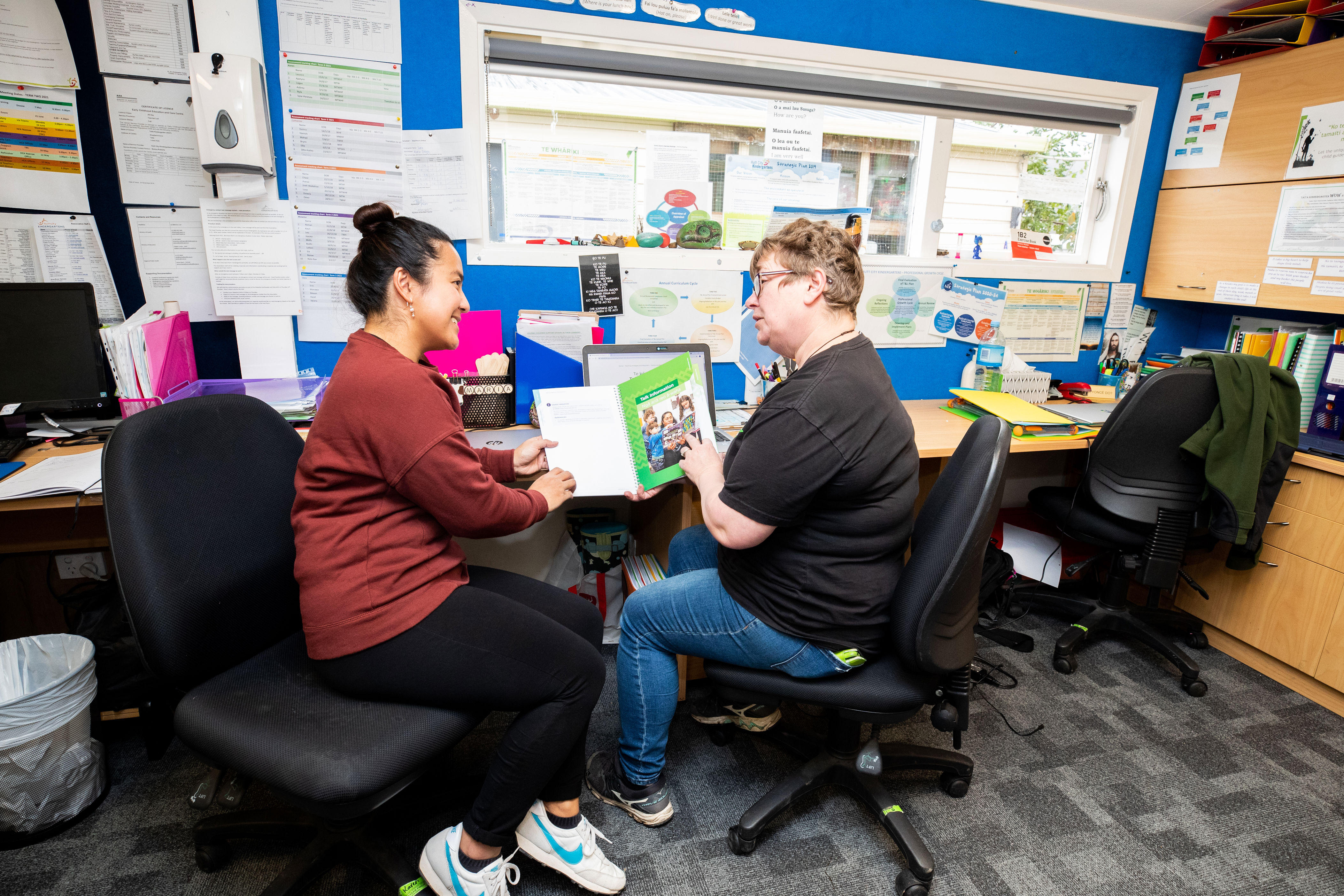 Two teachers discussing a resource to think about assessment for learning