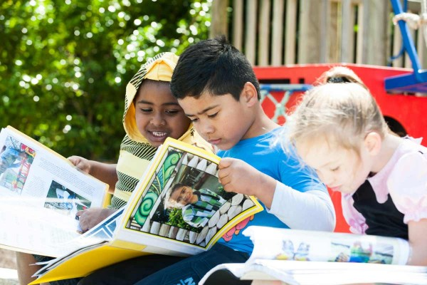  A group of children looking at their learning stories