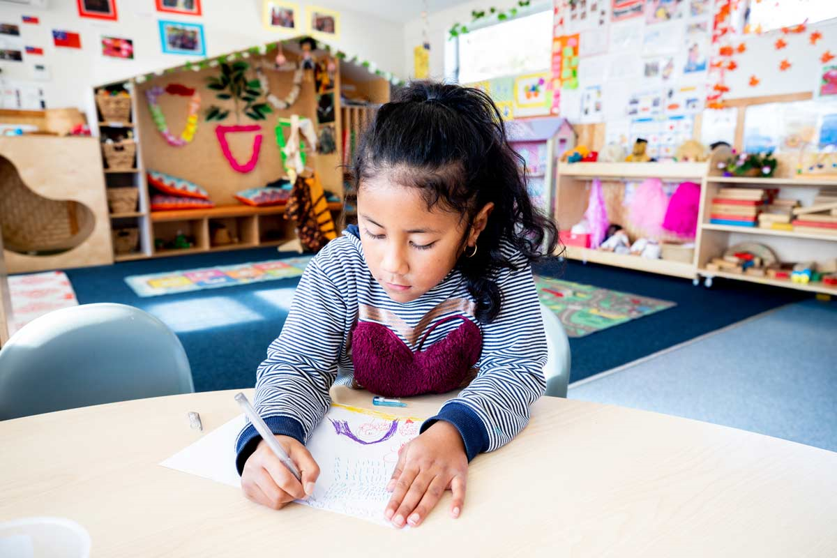 Child drawing at a desk