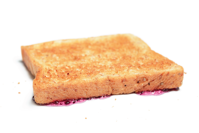 A piece of toast with Jam, dropped upside down.