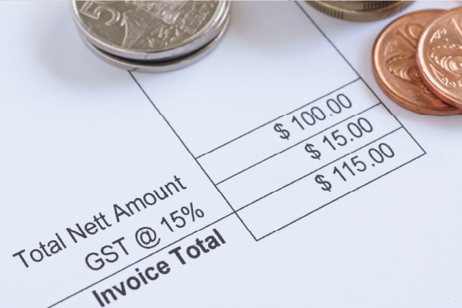 An image of an invoice total receipt with coins. 