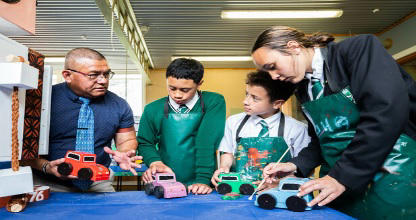 Students and a teacher working on a project