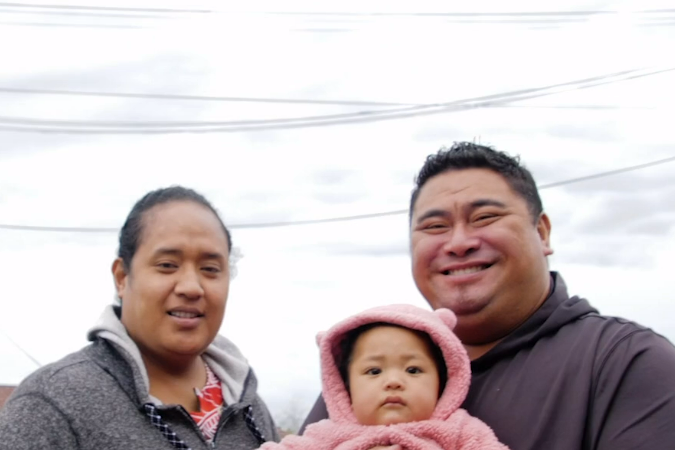 Family, mother, father, and toddler, smiling.