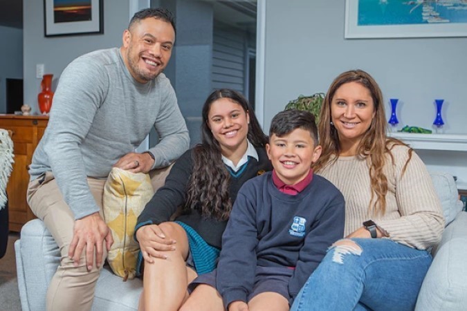 A family sitting together on a couch.