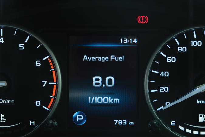 Dashboard of a vehicle showing speedometer and fuel gauge.