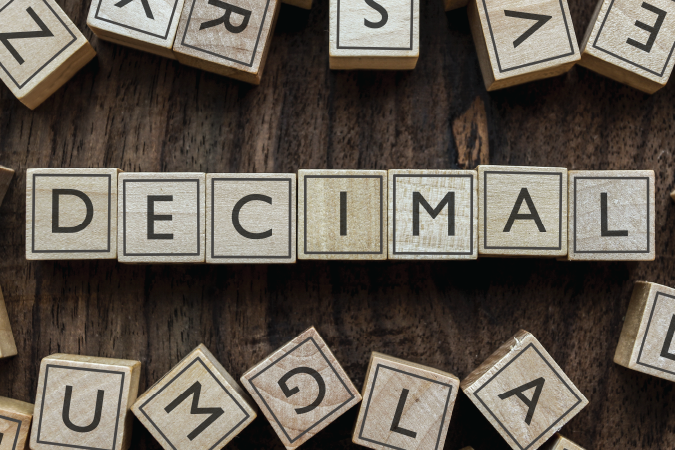 Blocks arranged in a neat row and arranged to spell the word "decimal".
