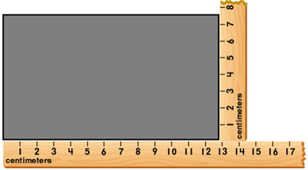 A grey rectangle with a wooden ruler placed along the bottom and a second ruler placed along the right hand side, measurement in centimeters. Base is 12.8cm, right hand side is 7.4cm.