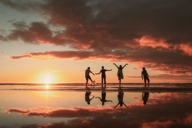 Silhouette of a family during sunset on the beach.